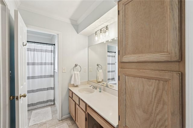 bathroom featuring ornamental molding and vanity