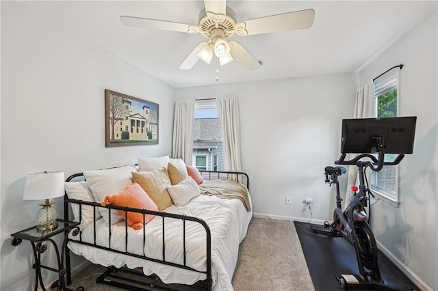 carpeted bedroom with baseboards and a ceiling fan