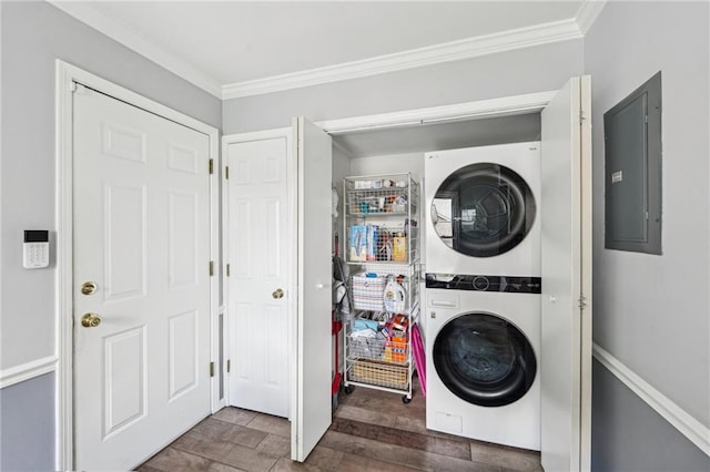 laundry room with estacked washer and dryer, electric panel, crown molding, and wood finished floors
