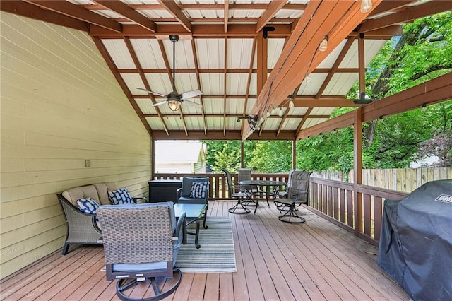 wooden deck featuring outdoor dining space, ceiling fan, a grill, and fence