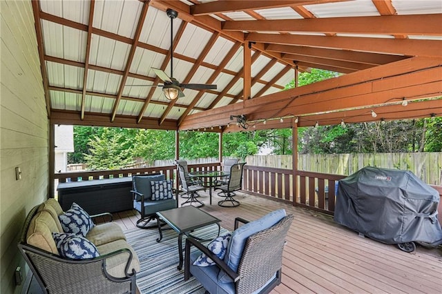 wooden terrace with ceiling fan, fence, area for grilling, outdoor dining area, and an outdoor hangout area
