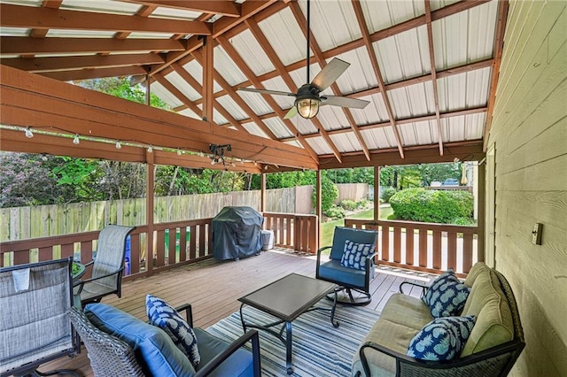 deck with ceiling fan, a fenced backyard, area for grilling, and an outdoor living space