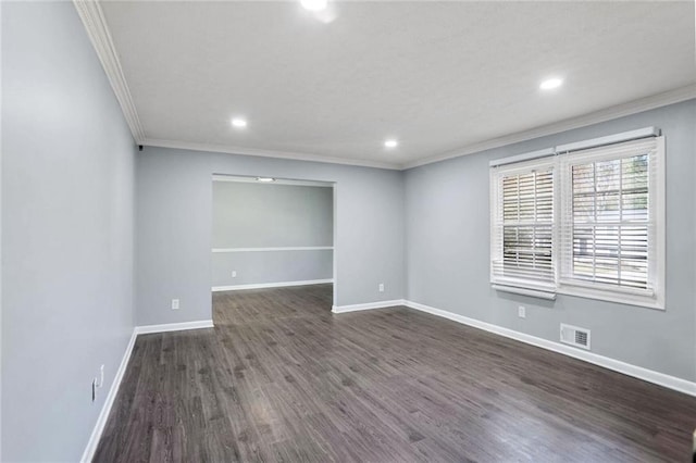 empty room featuring ornamental molding and dark wood-type flooring