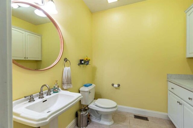 bathroom featuring sink, tile patterned floors, and toilet