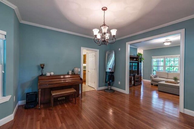 misc room with an inviting chandelier, ornamental molding, and hardwood / wood-style floors