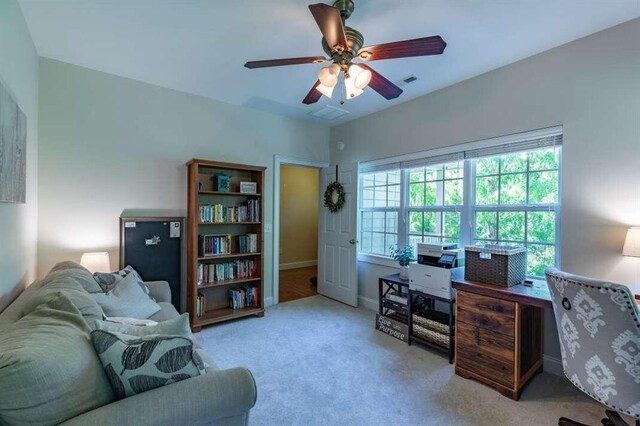 office space with ceiling fan and light colored carpet