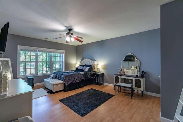 bedroom featuring ceiling fan and light hardwood / wood-style flooring