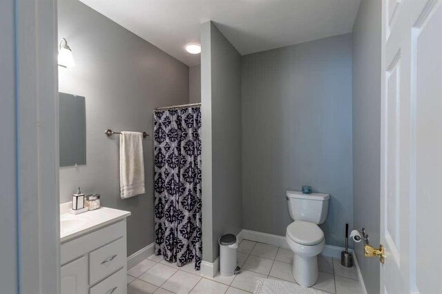 bathroom featuring tile patterned floors, vanity, and toilet