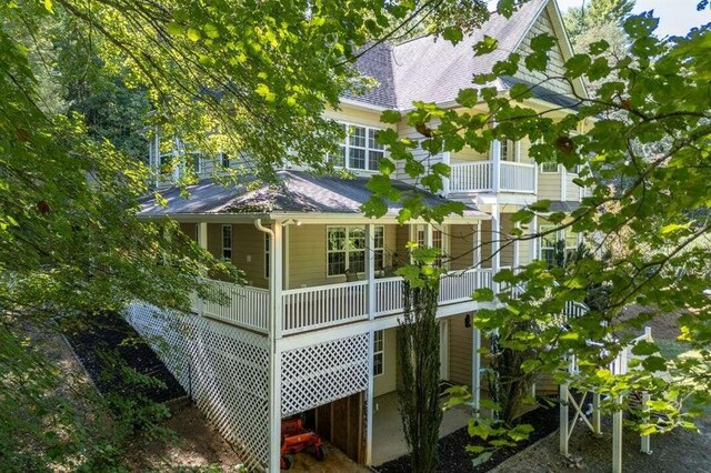 back of property featuring a balcony