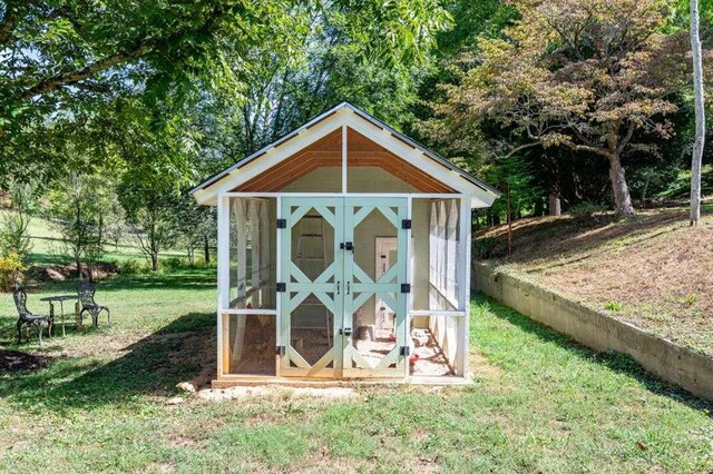 view of outbuilding featuring a lawn