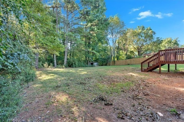 view of yard featuring stairs, fence, and a deck