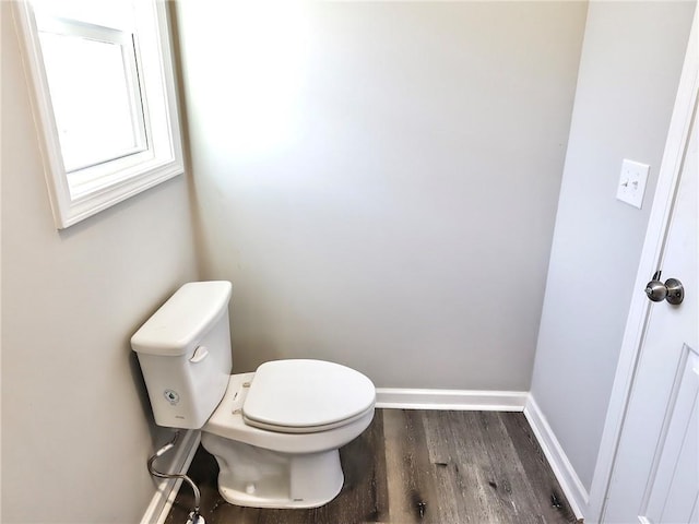 bathroom featuring wood-type flooring and toilet