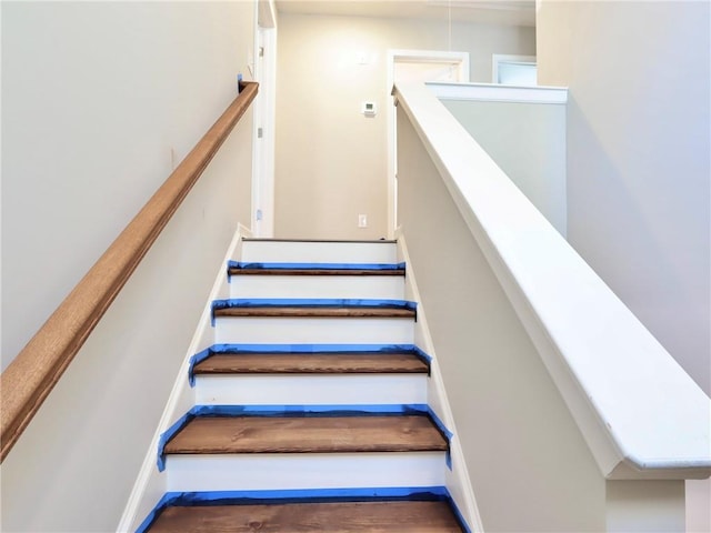 stairs featuring hardwood / wood-style flooring