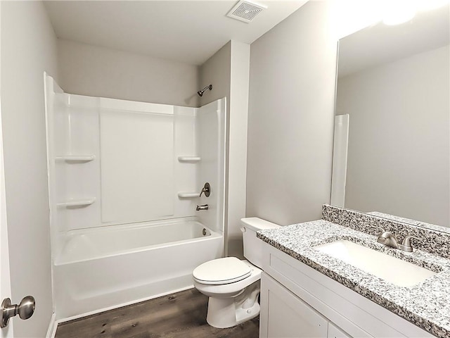 full bathroom featuring hardwood / wood-style floors, vanity, toilet, and shower / bathtub combination