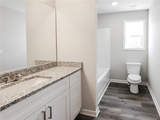 full bathroom with vanity, wood-type flooring, shower / bathtub combination, and toilet