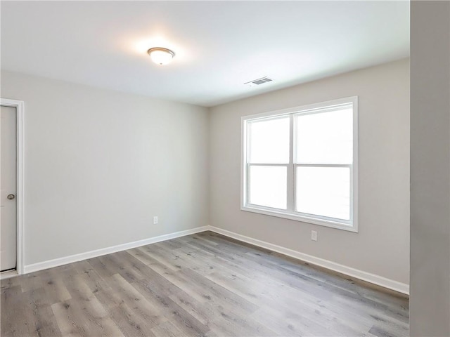 unfurnished room with light hardwood / wood-style flooring