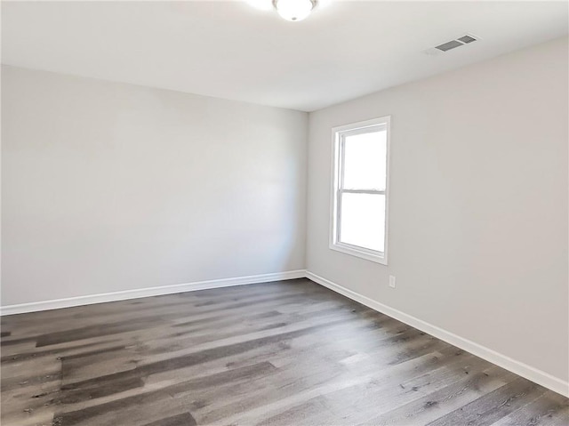 unfurnished room featuring dark wood-type flooring