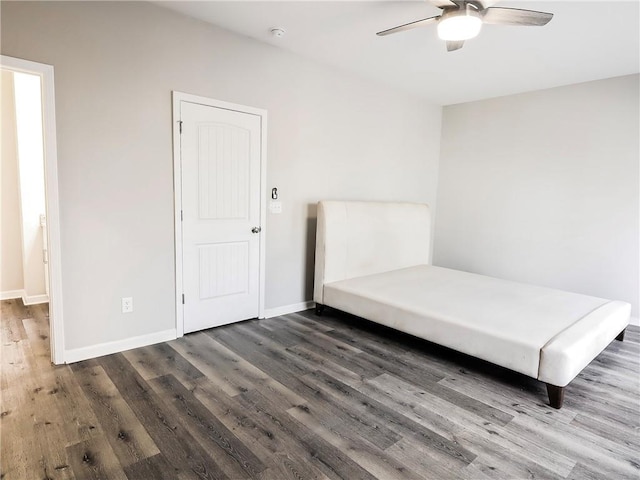 unfurnished bedroom featuring ceiling fan and dark hardwood / wood-style floors