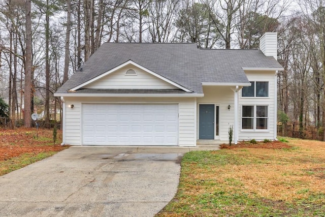 view of front of property featuring driveway, a front lawn, a chimney, and an attached garage