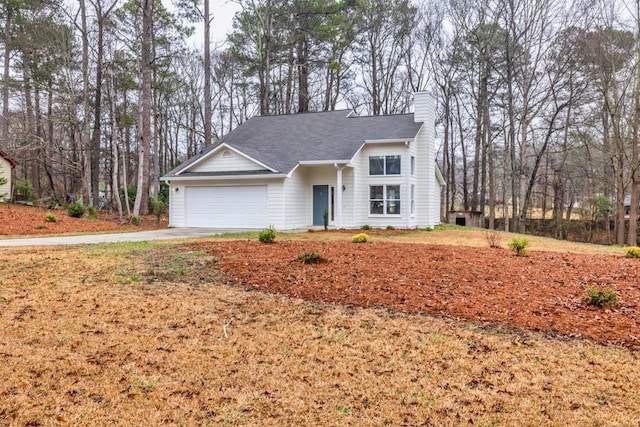 view of front of home with a garage, driveway, and a chimney