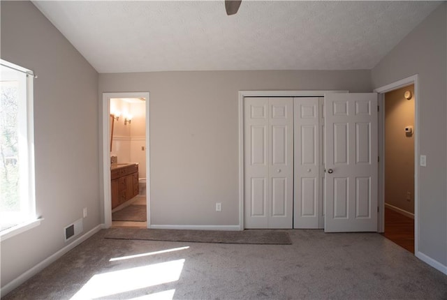 unfurnished bedroom with a closet, carpet, and multiple windows