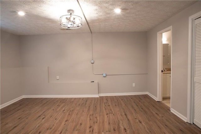 unfurnished room featuring baseboards and wood finished floors