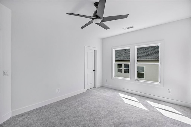 empty room with ceiling fan, baseboards, visible vents, and carpet flooring