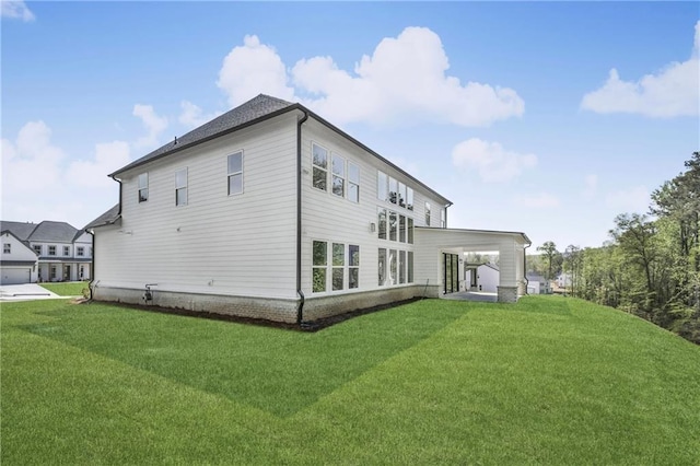 rear view of property featuring a lawn