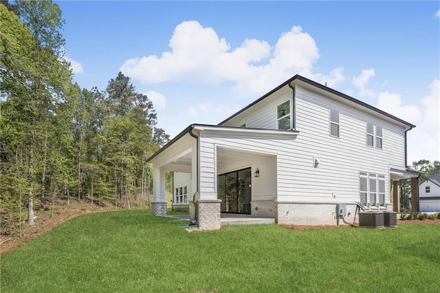 rear view of property with a lawn