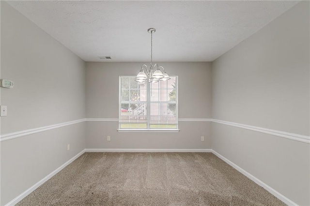 6181 E Fayetteville Dr, Riverdale, GA 30296 - carpeted empty room with a chandelier and a textured ceiling
