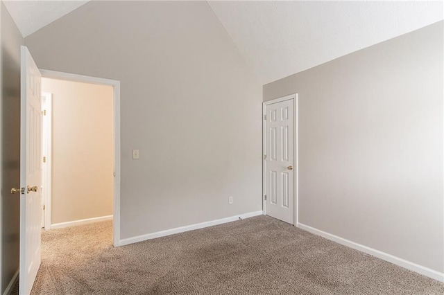 6181 E Fayetteville Dr, Riverdale, GA 30296 - carpeted empty room featuring vaulted ceiling and baseboards