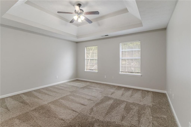 6181 E Fayetteville Dr, Riverdale, GA 30296 - spare room with a tray ceiling, carpet, and a ceiling fan