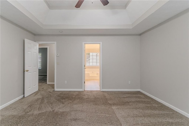 6181 E Fayetteville Dr, Riverdale, GA 30296 - unfurnished bedroom with a tray ceiling, carpet, ensuite bath, and ceiling fan