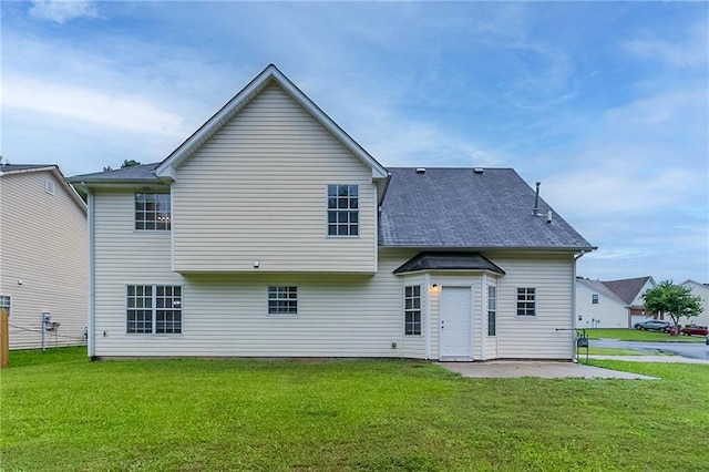 6181 E Fayetteville Dr, Riverdale, GA 30296 - rear view of house featuring a patio and a lawn