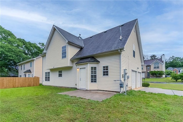 6181 E Fayetteville Dr, Riverdale, GA 30296 - back of house with an attached garage, driveway, and a patio