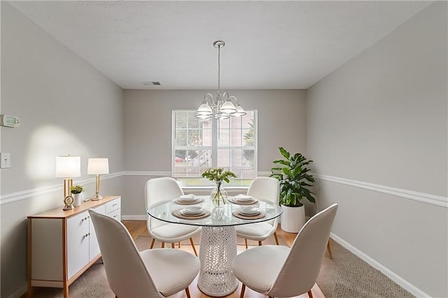 6181 E Fayetteville Dr, Riverdale, GA 30296 - dining space featuring a chandelier and baseboards