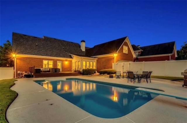 view of pool with a patio area, a fenced backyard, a diving board, and a fenced in pool