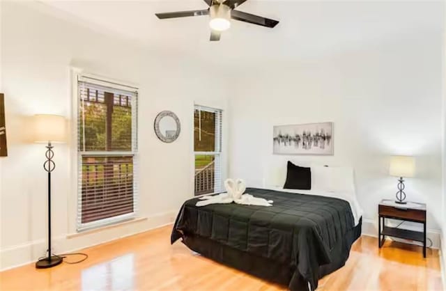 bedroom featuring a ceiling fan and wood finished floors