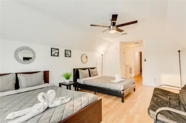 bedroom featuring light wood-type flooring, visible vents, and ceiling fan