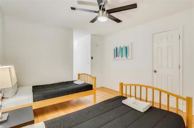 bedroom with a ceiling fan and wood finished floors