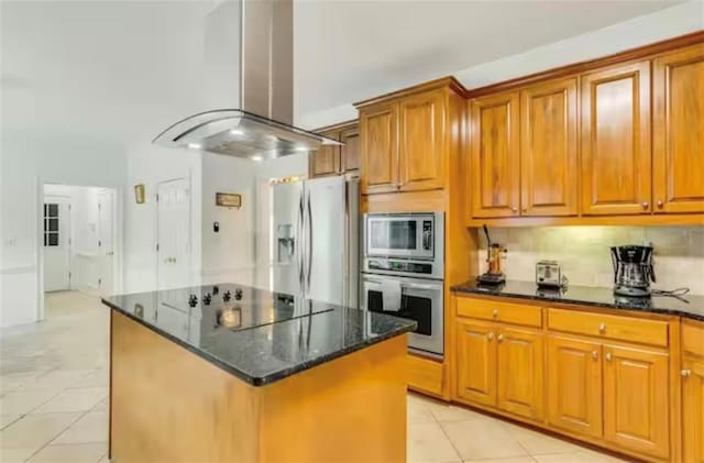 kitchen featuring appliances with stainless steel finishes, a kitchen island, brown cabinets, and island range hood