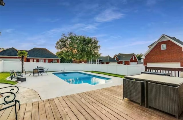 view of swimming pool featuring a deck, a patio area, a fenced backyard, and a fenced in pool