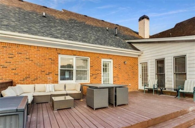 wooden deck with an outdoor living space