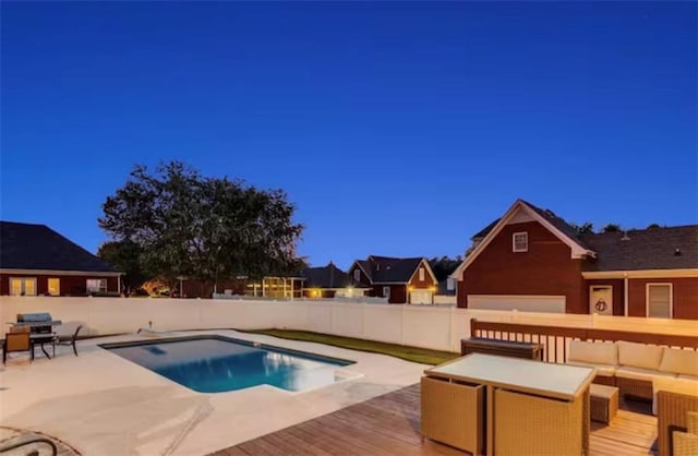 view of swimming pool with a fenced in pool, fence, a deck, and an outdoor hangout area