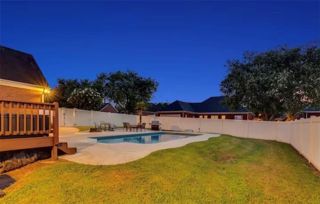 view of pool featuring a deck, a patio, a fenced backyard, a yard, and a fenced in pool