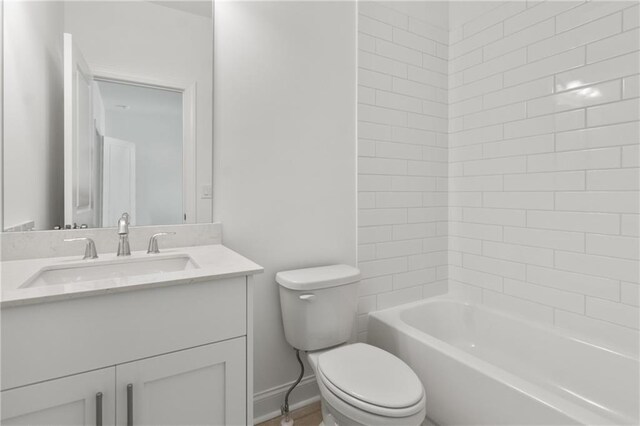 bathroom with vanity, washtub / shower combination, and toilet
