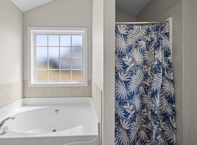 bathroom featuring lofted ceiling