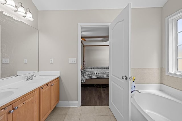 bathroom featuring tile patterned floors, a bathing tub, and vanity