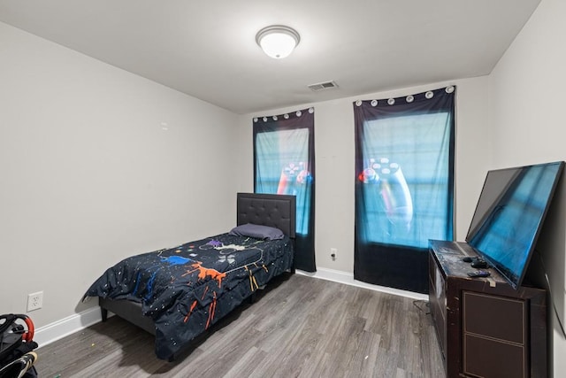 bedroom with hardwood / wood-style flooring