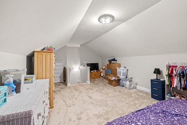 bedroom with lofted ceiling and light colored carpet